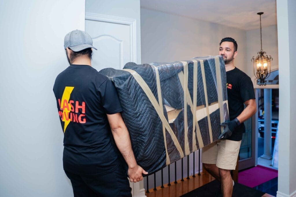 Flash Moving team loading wrapped furniture into truck at GTA residential move
